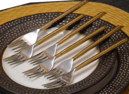 Gold stainless steel dinner forks set of 6 with striped handles on a textured charger plate on Tampa Home & Garden Store