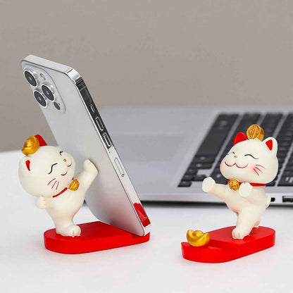Fortune Cat Phone Stand with two white Maneki Neko figures on red bases and gold coins, holds smartphones Shaketea on Tampa Home & Garden Store