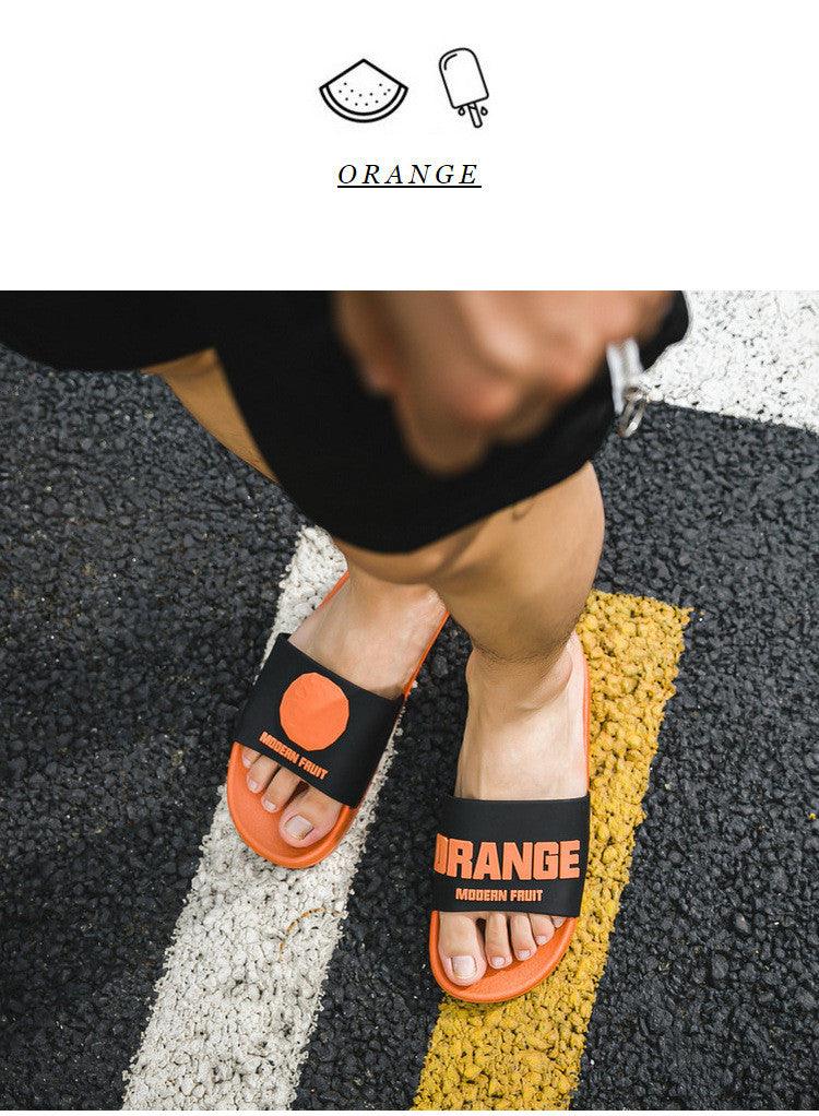 Women Fruit Slides elastic non slip bath slippers, orange sole with black strap and orange text on Tampa Home & Garden Store