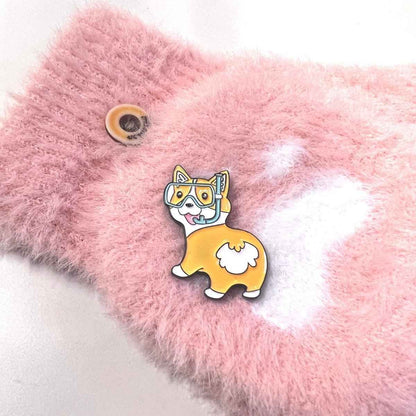 Fun corgi enamel pin with diving goggles on pink fluffy backdrop on Tampa Home & Garden Store