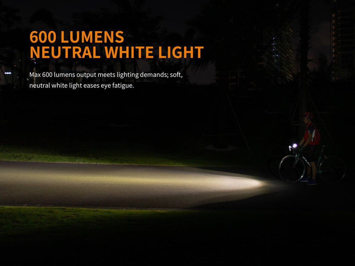 Fenix BC25R LED Bike Light mounted on a cyclist at night; bright beam lights the road on Tampa Home & Garden Store