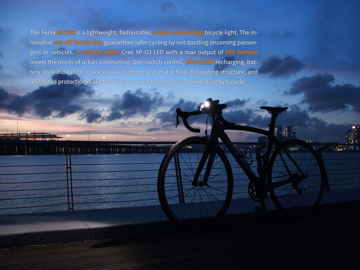 Fenix BC25R LED Bike Light on a black road bike at dusk by the water with a bright front beam on Tampa Home & Garden Store