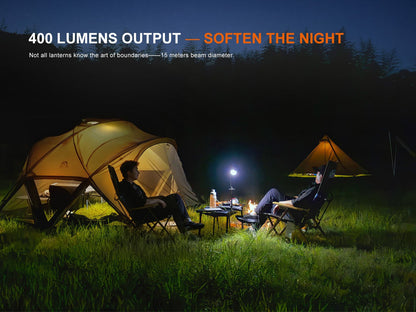 CL20R Pro Smart Multicolor Camping Lantern by Fenix Store at a night campsite with tents on Tampa Home & Garden Store