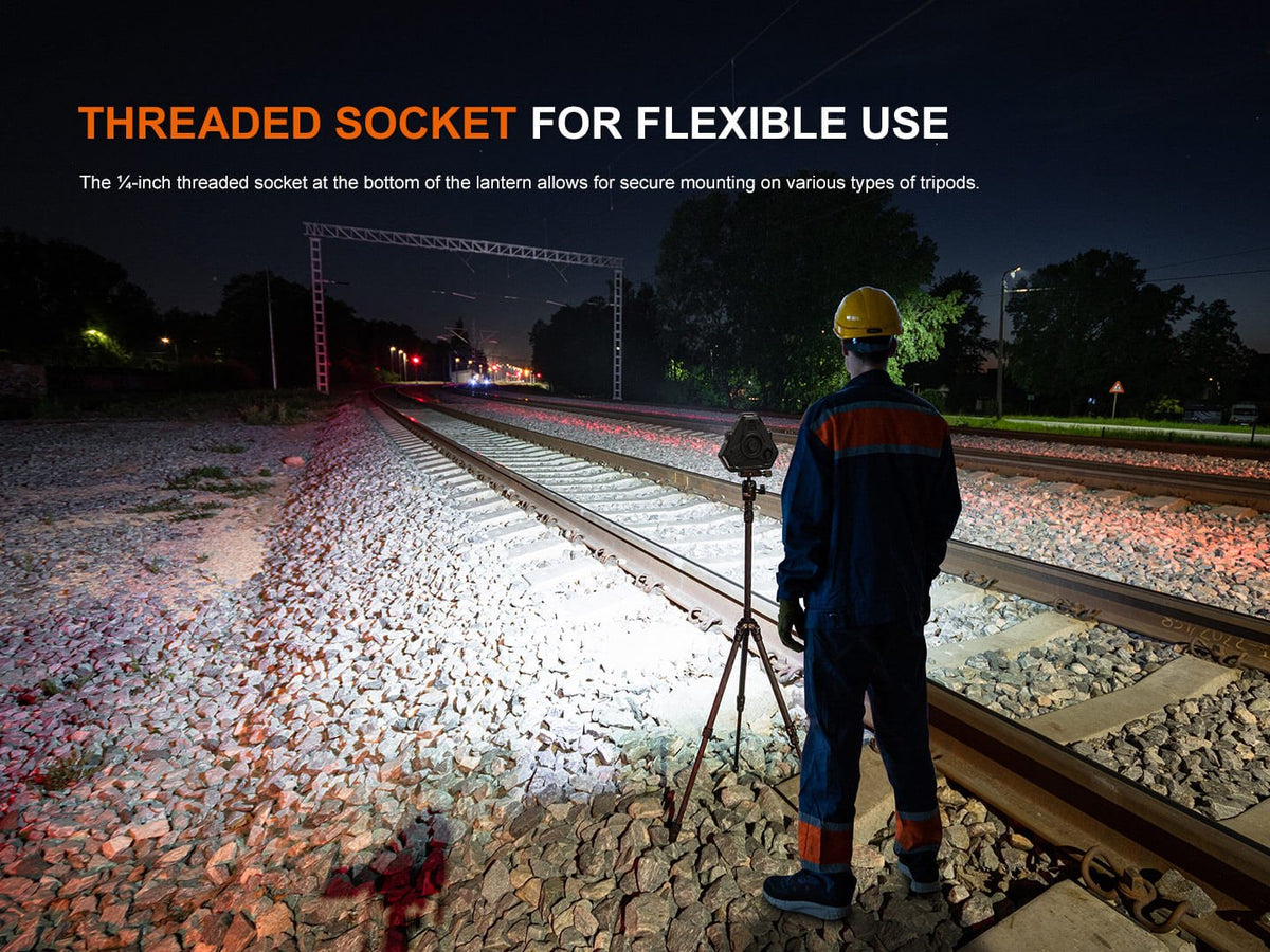 Fenix CP50R lantern on tripod lighting railway tracks at night with a worker in safety gear on Tampa Home & Garden Store