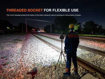 Fenix CP50R lantern on tripod lighting railway tracks at night with a worker in safety gear on Tampa Home & Garden Store
