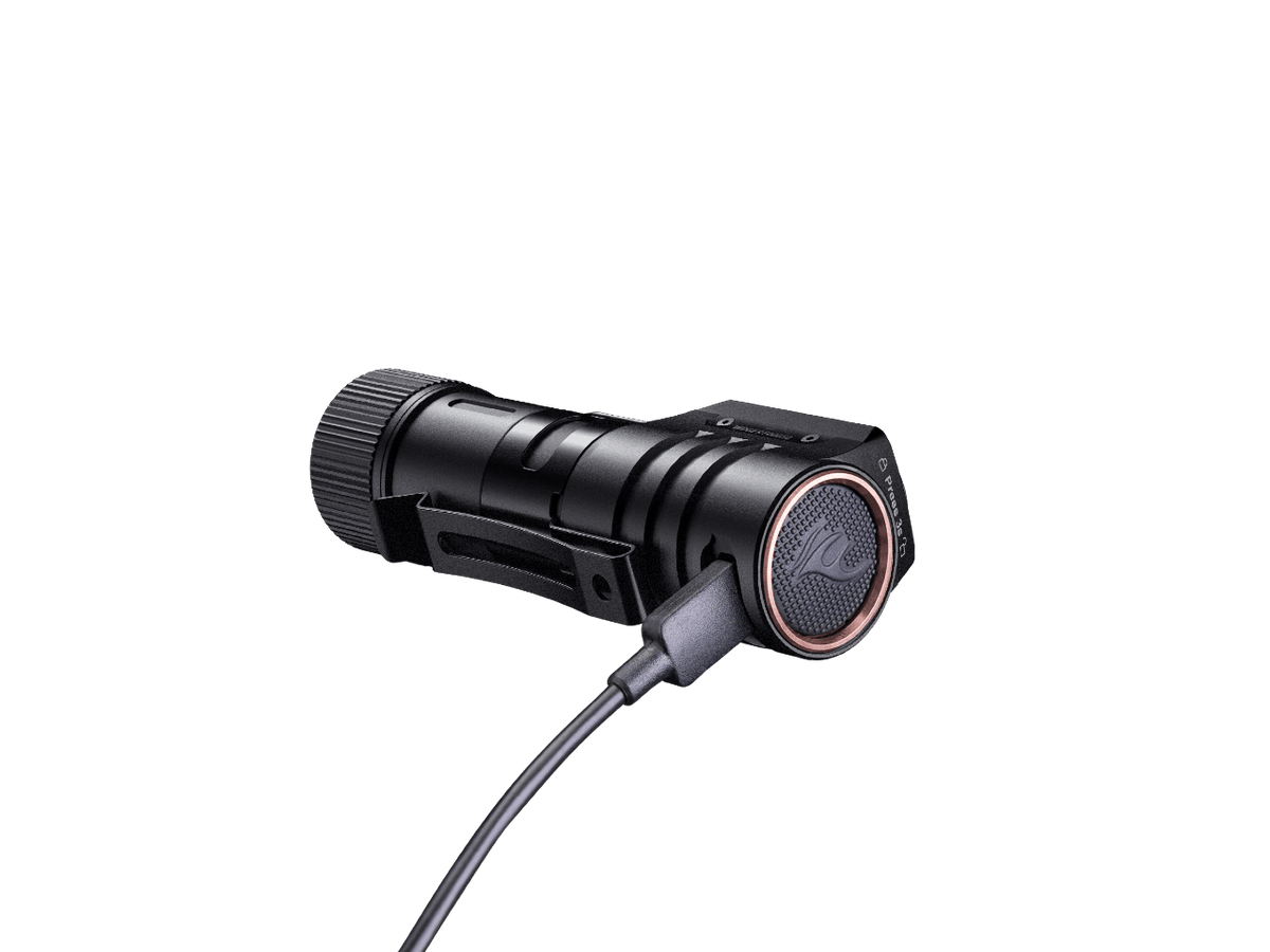 Fenix HM71R headlamp, rechargeable LED, black metal body with copper bezel and charging cable on Tampa Home & Garden Store
