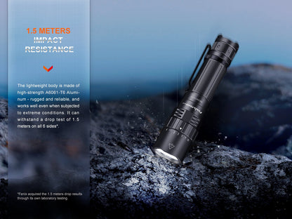 Fenix PD40R V3 rechargeable tactical flashlight, black aluminum body with grip, angled on rocks on Tampa Home & Garden Store