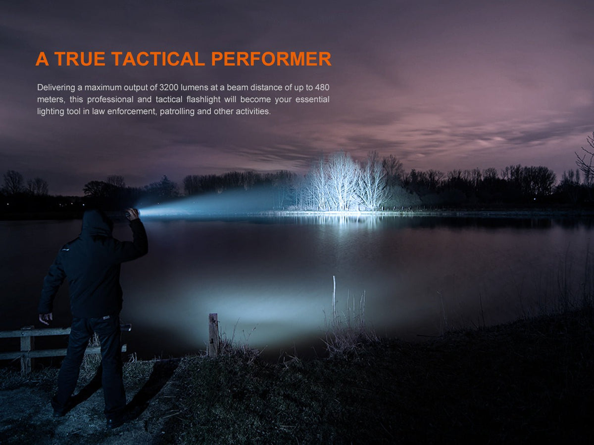 Fenix TK22R rechargeable tactical flashlight by Fenix Store with blue night beam over a lake on Tampa Home & Garden Store