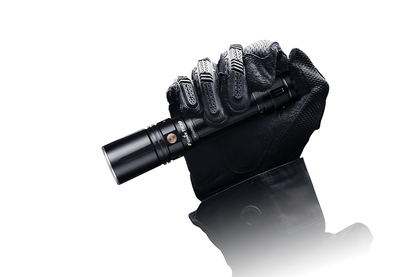 Fenix TK30 White Laser LED Flashlight gripped by black tactical glove on Tampa Home & Garden Store