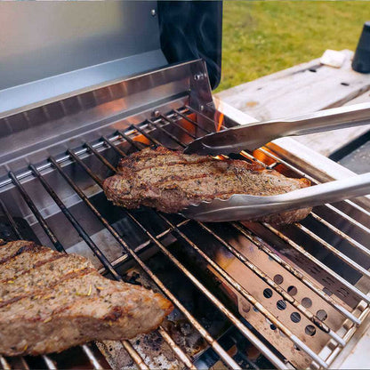 G22 stainless tabletop propane grill grilling steak on stainless grates outdoors on Tampa Home & Garden Store