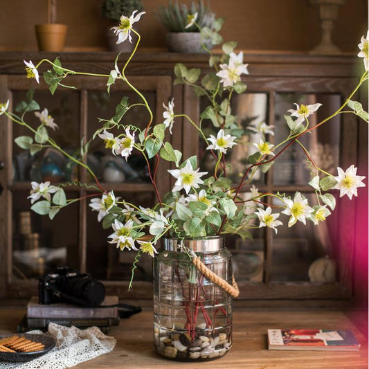 Faux silk German Clematis stem in white, RusticReach, 40-inch tall, arranged in a glass jar on Tampa Home & Garden Store