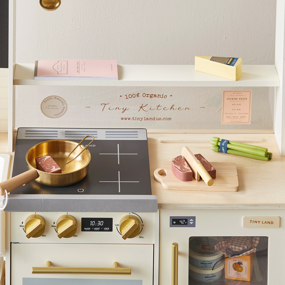 Tiny Land BistroSwitch Play Kitchen with brass pot on black stove and wooden cutting board on Tampa Home & Garden Store
