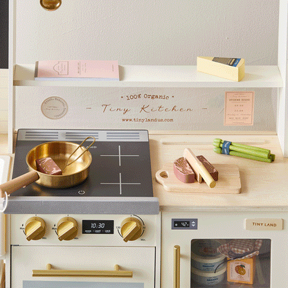 Tiny Land BistroSwitch Play Kitchen with brass pot on black stove and wooden cutting board on Tampa Home & Garden Store