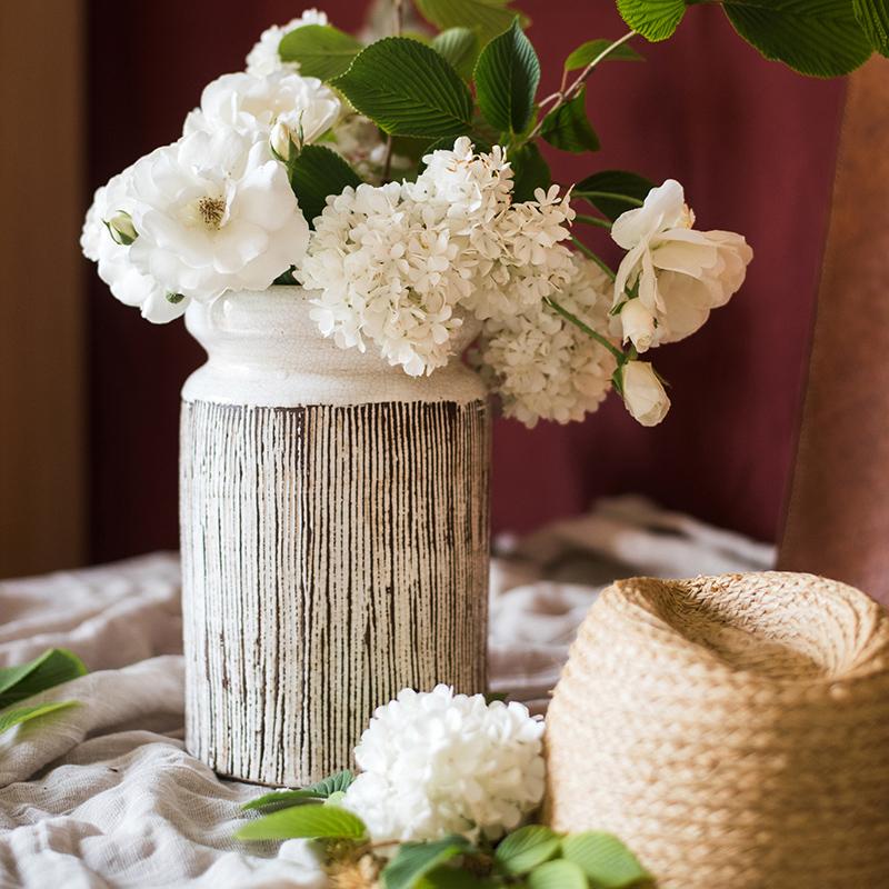 Glazed ceramic vase by RusticReach with abstract brown stripes on white, white flowers on Tampa Home & Garden Store