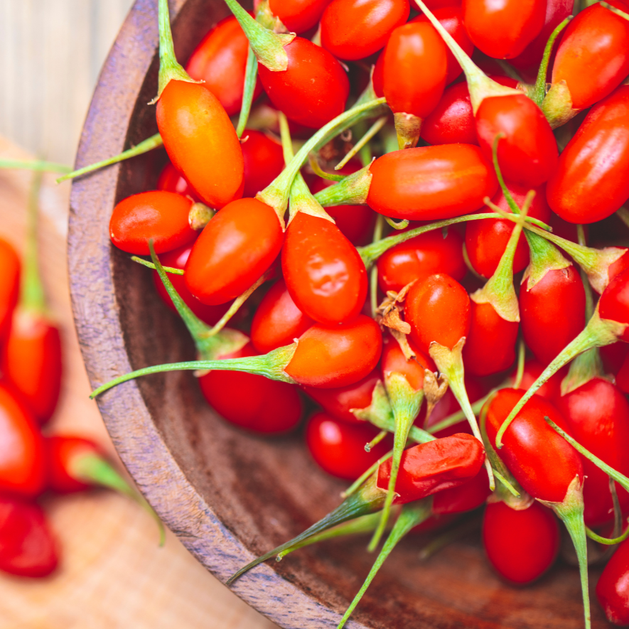 Goji berries in a wooden bowl, bright red and plump on Tampa Home & Garden Store