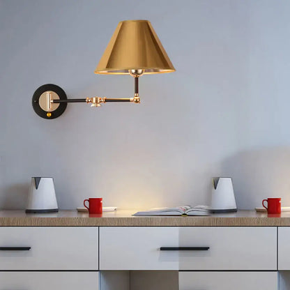 Decorbites gold black cone wall sconce with brass shade on round black backplate on Tampa Home & Garden Store