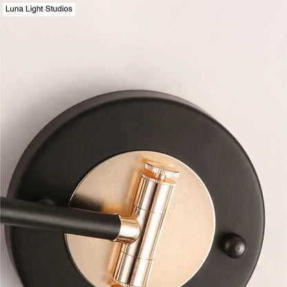 Gold black cone wall sconce with black backplate and gold cylindrical bulb holder on Tampa Home & Garden Store