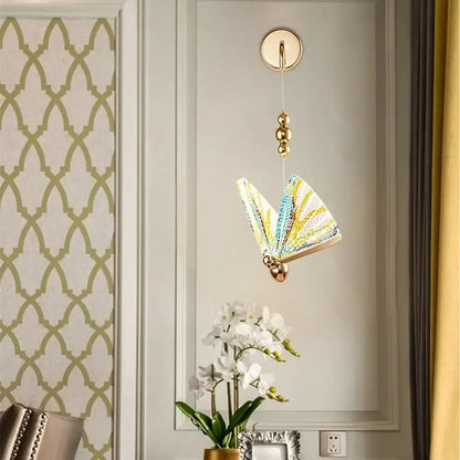 Gold Butterfly LED Wall Light with colorful glass wings, suspended by a gold chain on Tampa Home & Garden Store