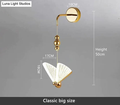 Gold butterfly LED wall light by Decorbites with gold bead chain and white butterfly motif on Tampa Home & Garden Store