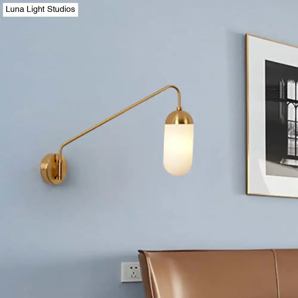 Brass frosted wall sconce by Decorbites with curved arm and cylindrical shade, wall light on Tampa Home & Garden Store