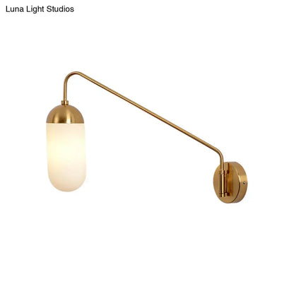 Brass frosted glass wall sconce with curved arm and wall mount on Tampa Home & Garden Store