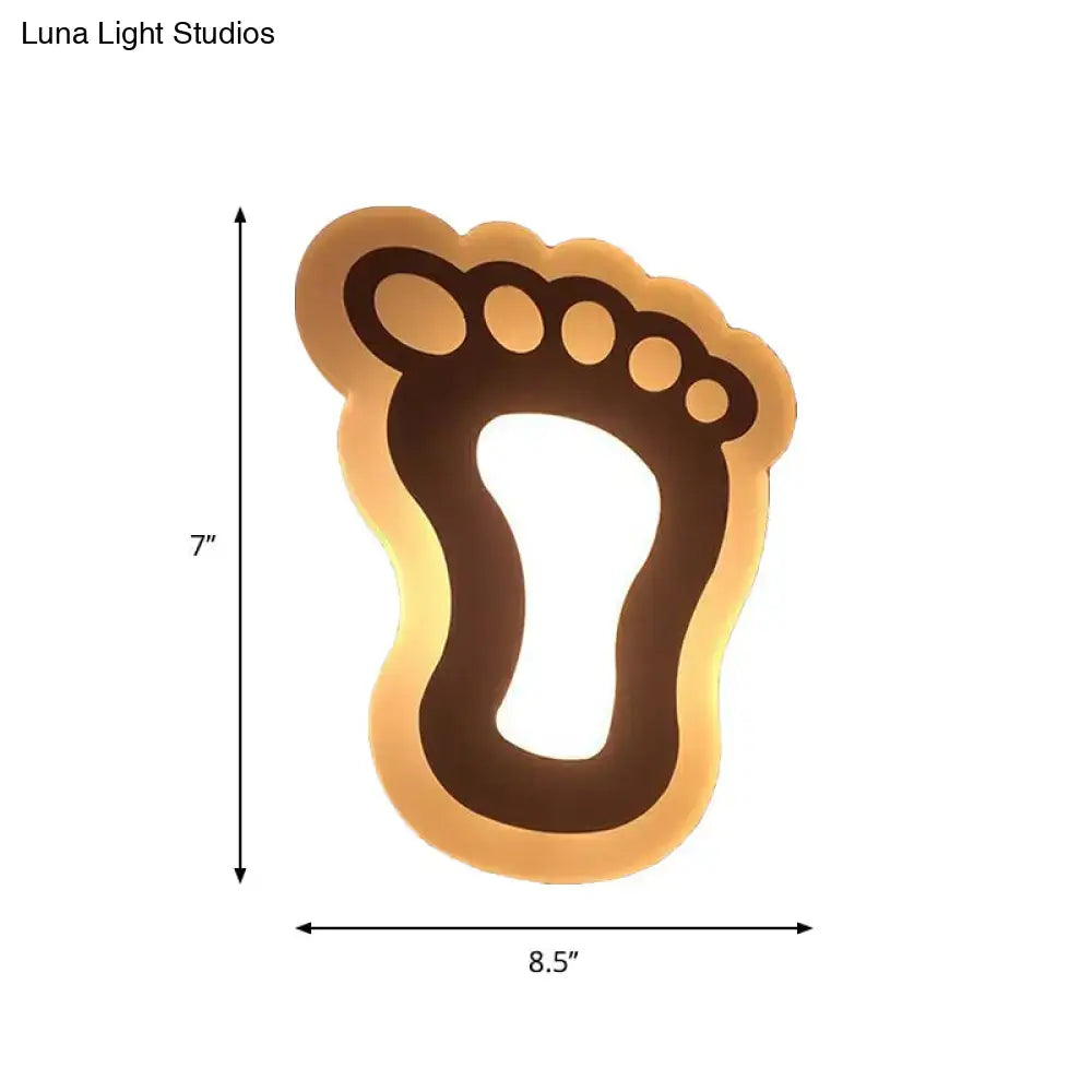 Decorbites Gold Crescent LED Sconce in footprint silhouette with warm amber backlight on Tampa Home & Garden Store