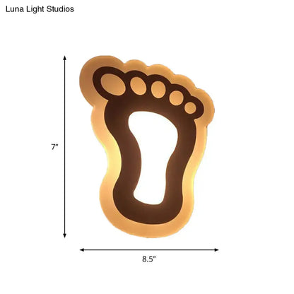 Decorbites Gold Crescent LED Sconce in footprint silhouette with warm amber backlight on Tampa Home & Garden Store