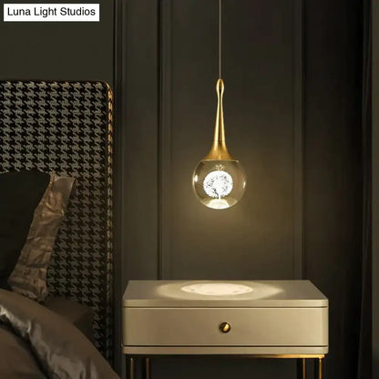 Gold crystal glass LED pendant light by Decorbites over a white nightstand on Tampa Home & Garden Store