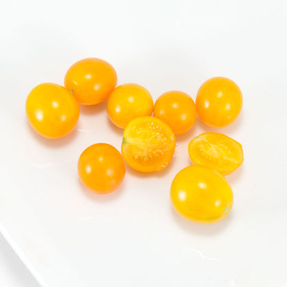 Gold Nugget Tomato seeds, yellow cherry fruits shown whole and halved, Seedtime Store on Tampa Home & Garden Store