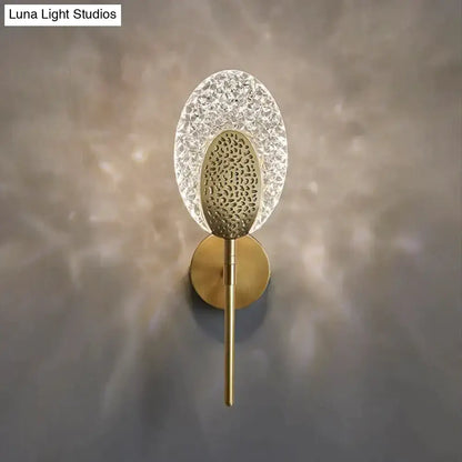 Gold textured wall lamp with crystal-like oval surround and brass body by Decorbites on Tampa Home & Garden Store