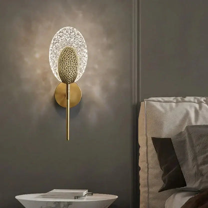 Gold Textured Wall Lamp by Decorbites, brass stem and clear crystal halo on dark wall on Tampa Home & Garden Store