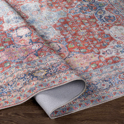 Boutique Rugs Rust Goma Vintage Area Rug red blue beige floral motif, rolled edge view on Tampa Home & Garden Store