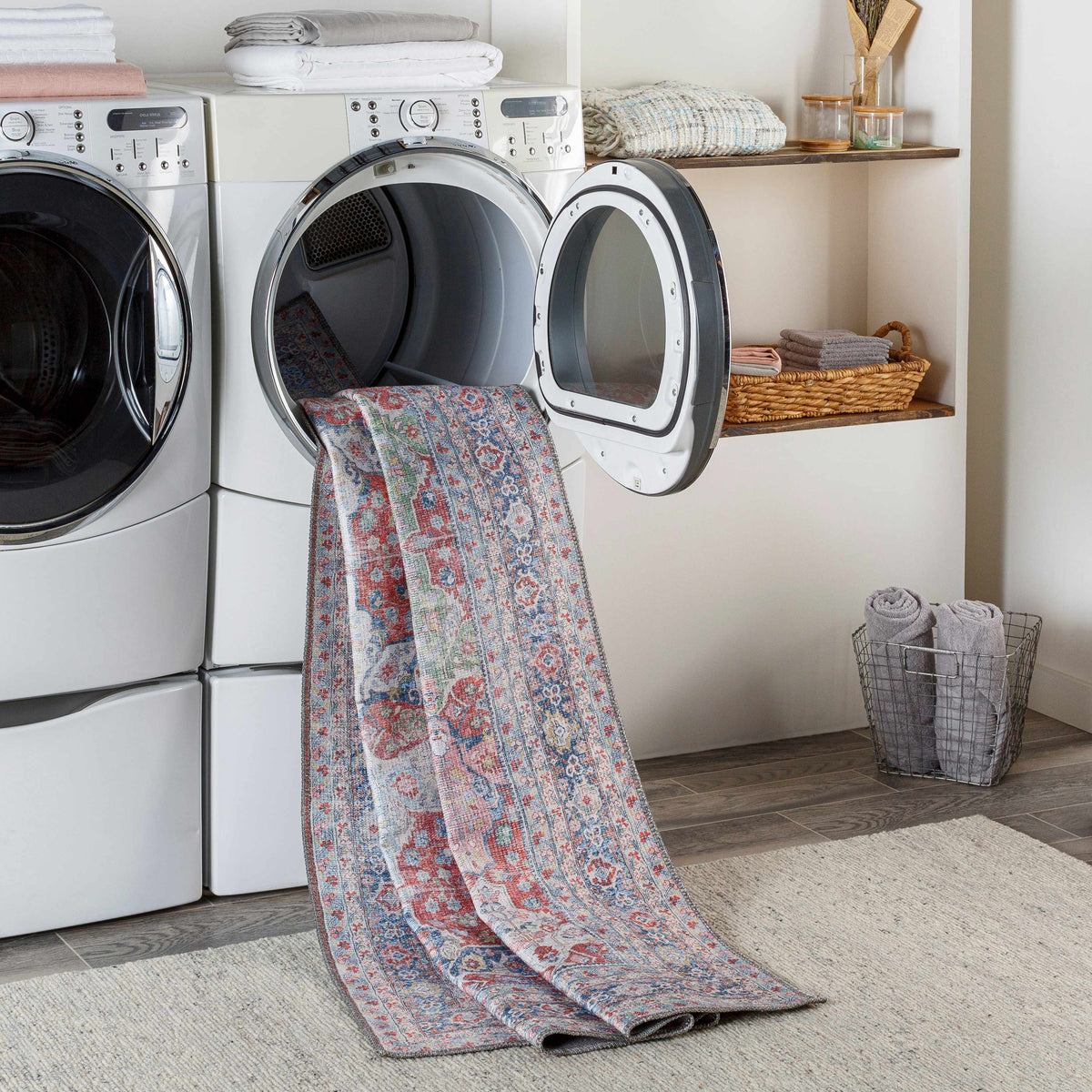 Rust Goma Vintage Area Rug by Boutique Rugs, multicolor distressed pattern draped over laundry room washers on Tampa Home & Garden Store