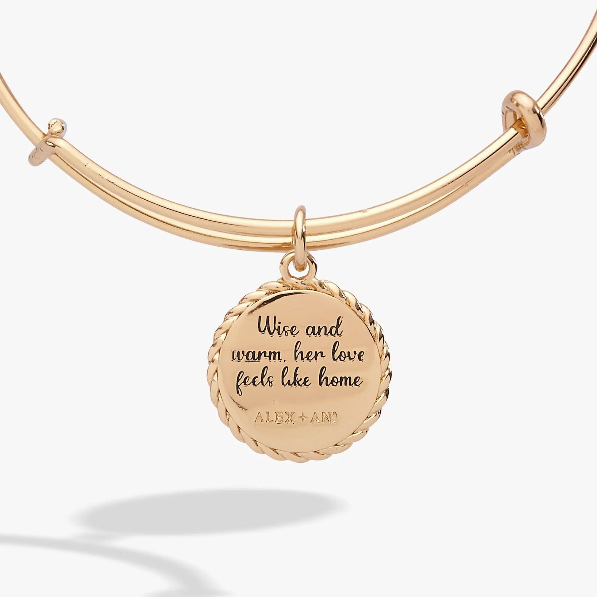 Gold-tone Alex and Ani charm bracelet with round pendant engraved Wise and warm, her love on Tampa Home & Garden Store