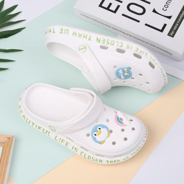 Stevvex white slip-on garden slippers with perforated upper and penguin graphic, pair on Tampa Home & Garden Store
