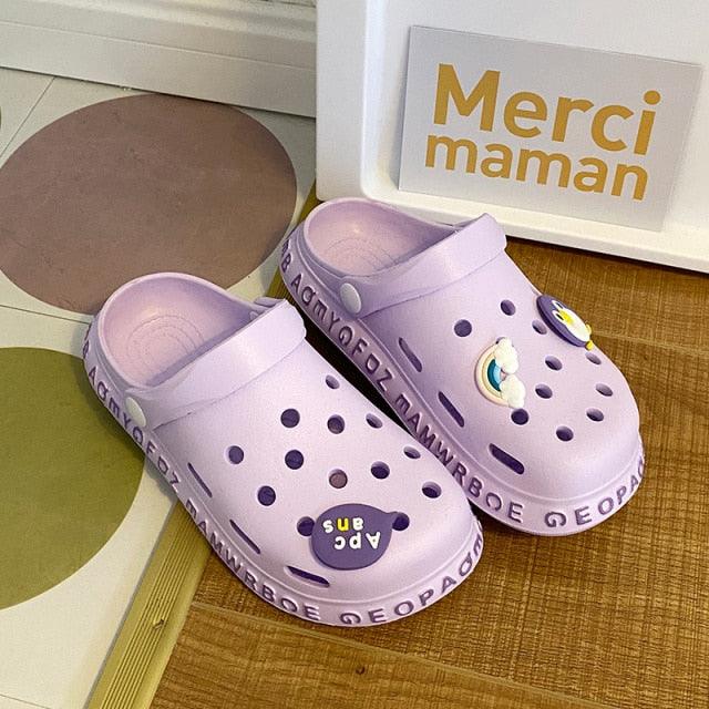 Stevvex lavender slip-on sandals pair with perforated uppers and decorative charms on Tampa Home & Garden Store