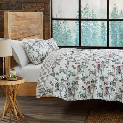 Holiday Printed Quilt Alfie Collection by Great Bay Home on bed with winter village pattern on Tampa Home & Garden Store