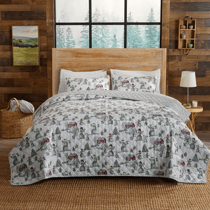 Holiday Printed Quilt Alfie Collection by Great Bay Home on bed with winter village scene on Tampa Home & Garden Store