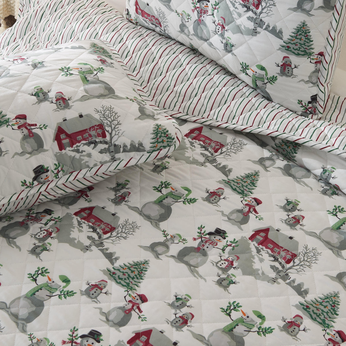Holiday Quilt Alfie Great Bay Home with snowmen and trees on white quilt with red border on Tampa Home & Garden Store