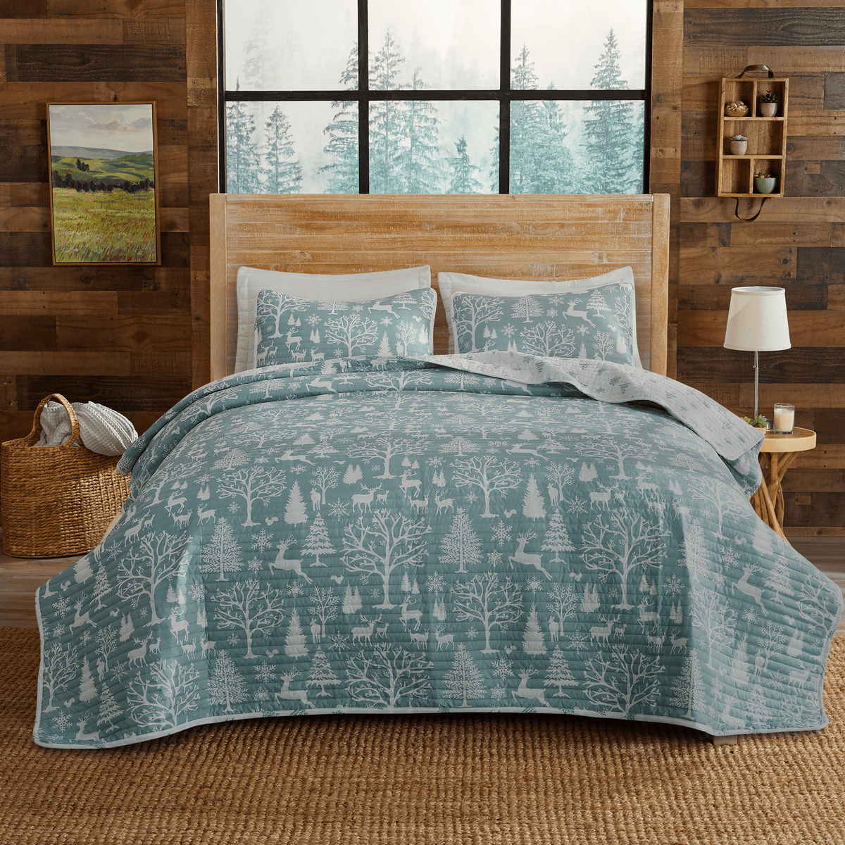 Lodge Woods Quilt by Great Bay Home in teal with woodland trees motif on a rustic bed on Tampa Home & Garden Store