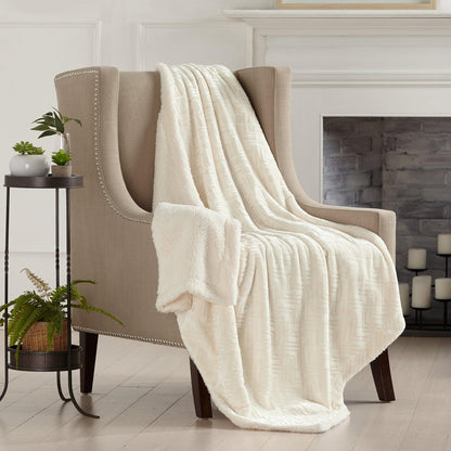 Velvet Plush Sherpa Luxury Bed Blanket in cream draped over beige upholstered chair on Tampa Home & Garden Store