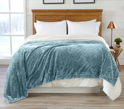 Velvet plush sherpa bed blanket teal from Great Bay Home, draped over a wooden headboard on Tampa Home & Garden Store