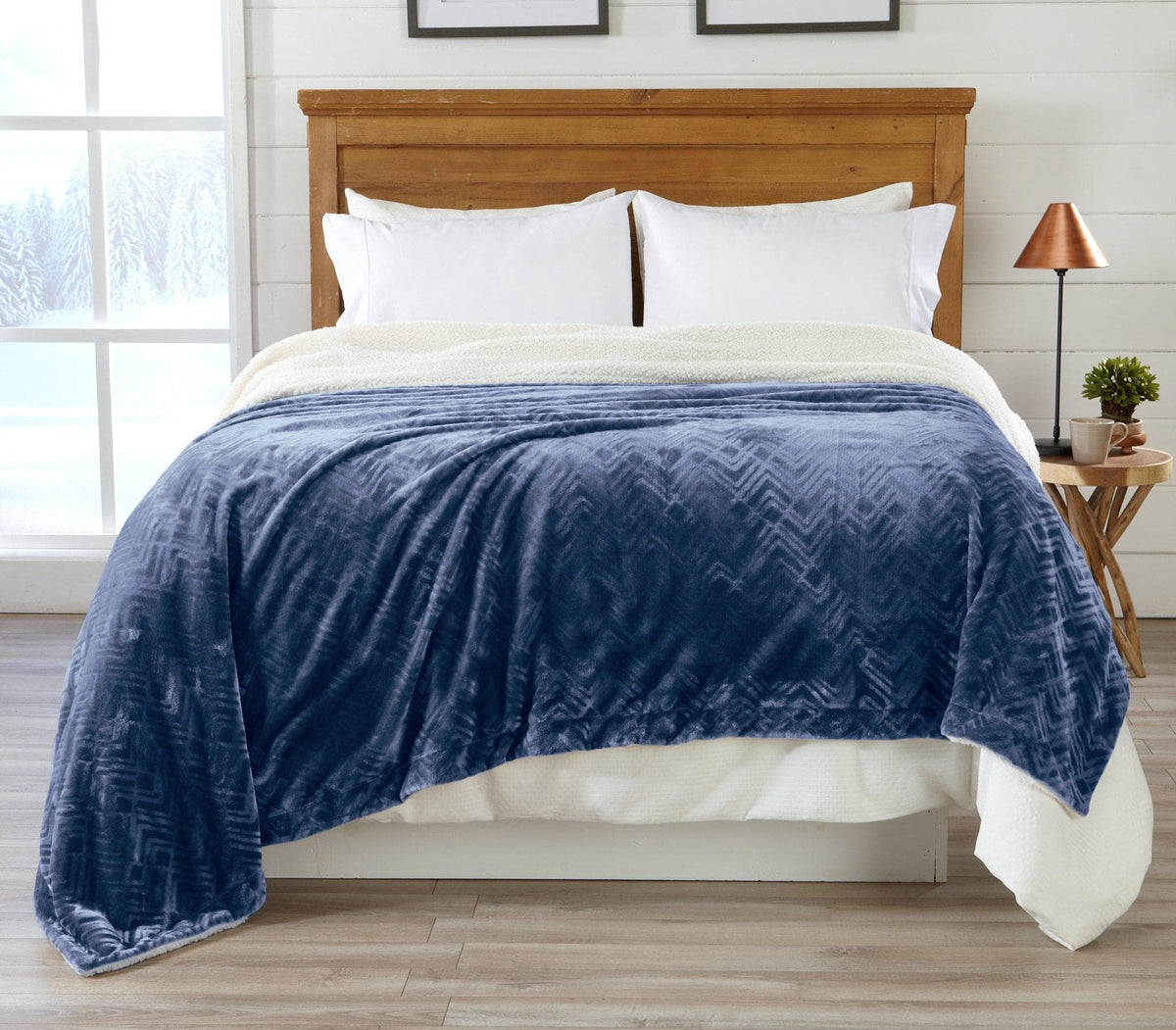 Blue Velvet Plush Sherpa Luxury Bed Blanket by Great Bay Home draped over a bed with pillows on Tampa Home & Garden Store