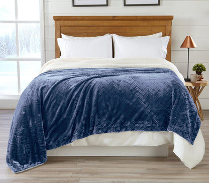 Blue Velvet Plush Sherpa Luxury Bed Blanket by Great Bay Home draped over a bed with pillows on Tampa Home & Garden Store