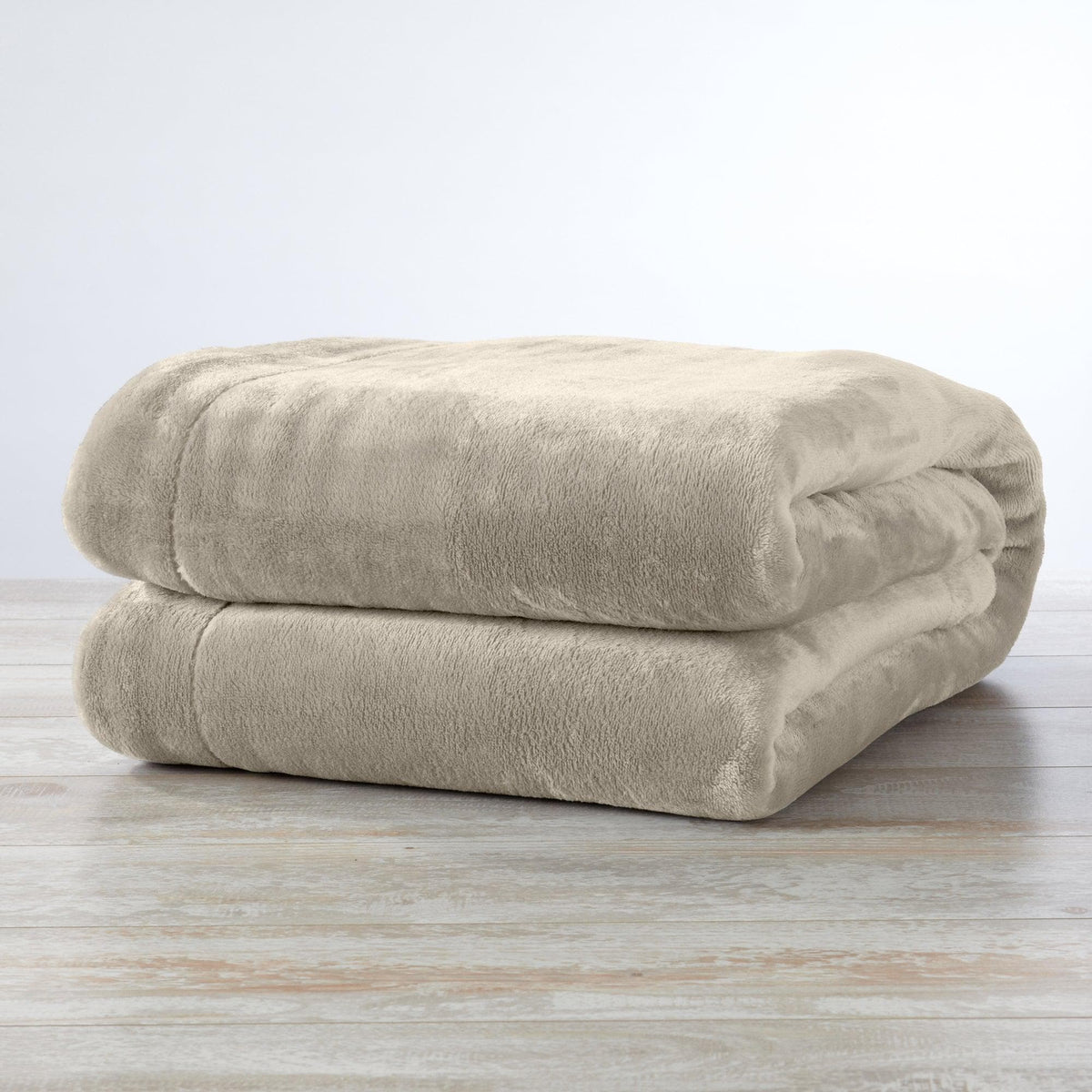 Velvet Plush Sherpa Luxury Bed Blanket beige folded on light wood floor on Tampa Home & Garden Store