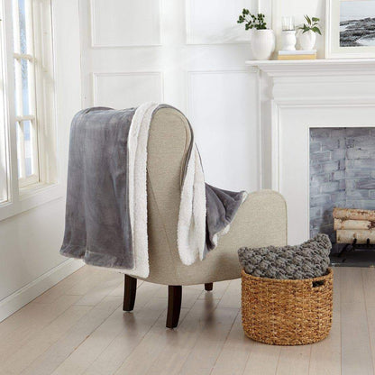 Grey Velvet Bed Blanket by Great Bay Home white sherpa lining on beige chair on Tampa Home & Garden Store