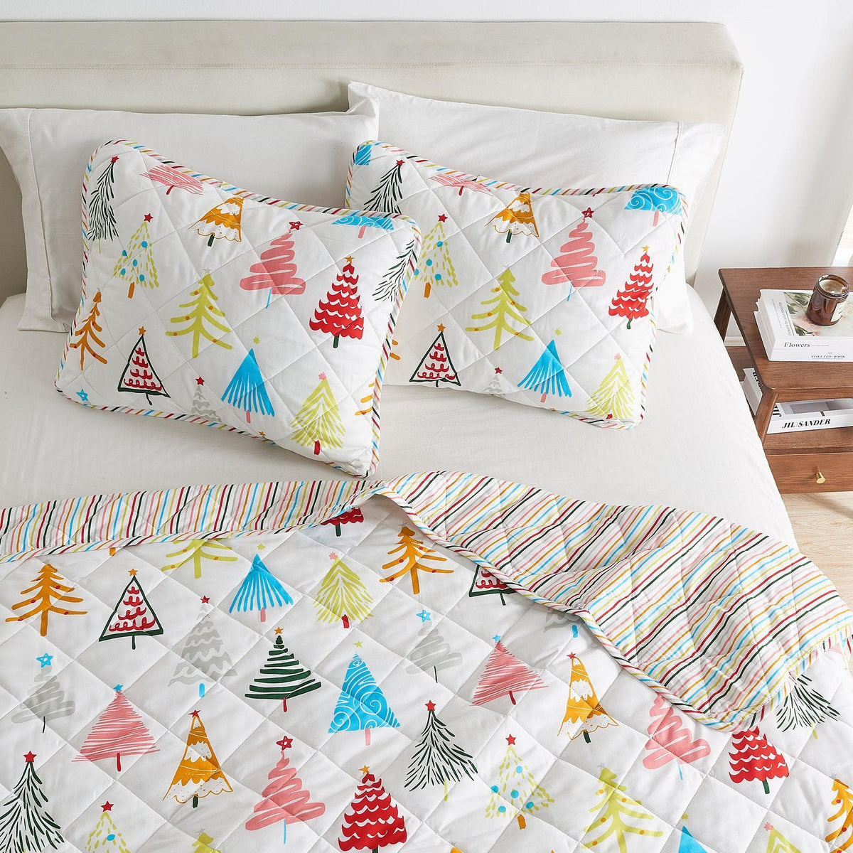 Colorful Holiday Quilt Set Great Bay Home with two tree-print shams on white quilted bedding on Tampa Home & Garden Store
