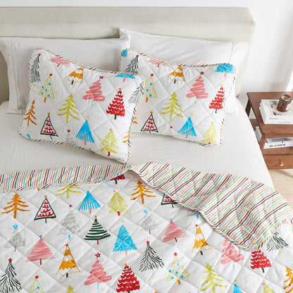 Colorful Holiday Quilt Set Great Bay Home with two tree-print shams on white quilted bedding on Tampa Home & Garden Store
