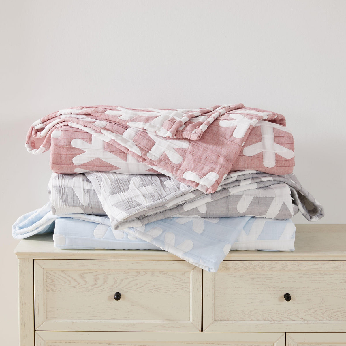 Matelassé Snowflake Quilt Set Nino Collection by Great Bay Home, quilts stacked pink gray blue on Tampa Home & Garden Store