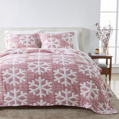 Matelassé Snowflake Quilt Set pink bedding with white snowflake motif on bed with matching pillows on Tampa Home & Garden Store